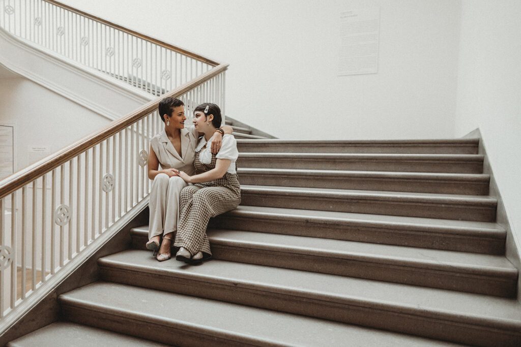 Lex and Aves sit on the stairs in the Art Institute and share a moment while the space is empty.